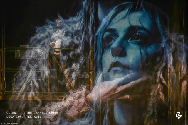 A veil between love and fate.

For Puccini’s Tosca at the Israeli Opera in Tel Aviv, Big Image premium printed the large-scale mesh backdrop that forms part of the production’s striking scenography.

Through light and transparency, the printed imagery appears and recedes, allowing performers and scenery to remain visible through the mesh.

Director: Ido Ricklin
Set Designer: Falko Herold
Lighting Designer: Nadav Barnea
Client & Partner: Props s.c.
Photos: Yuval Cadmon 
.
.
.
.
.
.
setdesign, setdesigner, scenography, scenicdesign, scenicdesigner, lightdesign, lightdesigner, productiondesign, productiondesigner

#147639